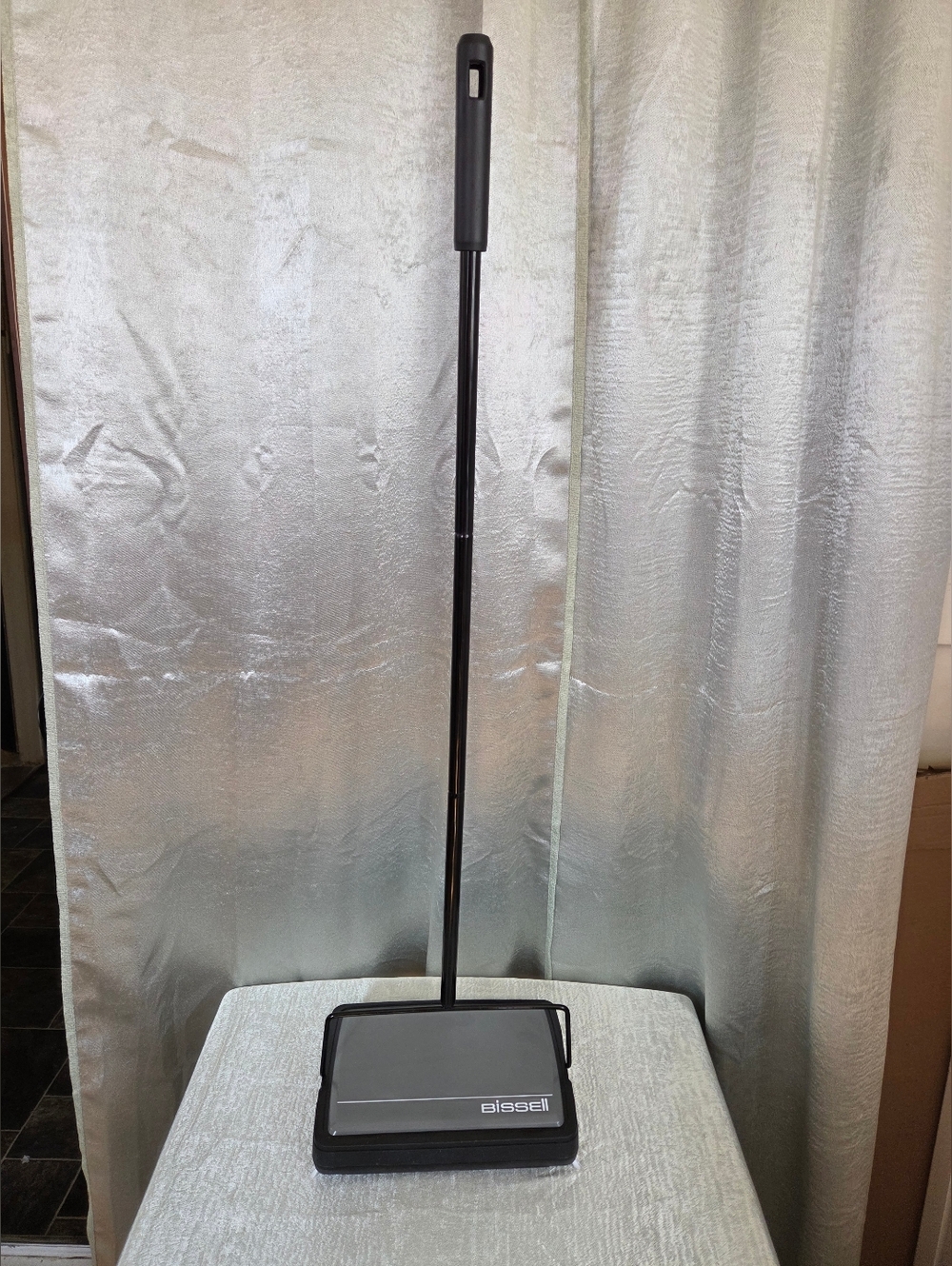 Bissell Cordless Floor Sweeper in Black and Silver.